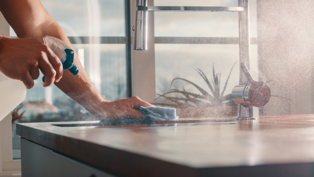 someone cleaning a kitchen, emphasizing the importance of organization and cleanliness for a healthy living environment.